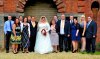 Bride and Groom with family under arch.jpg