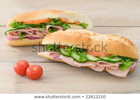 stock-photo-ham-salad-baguettes-on-rustic-table-with-tomato-garnish-22612210.jpg